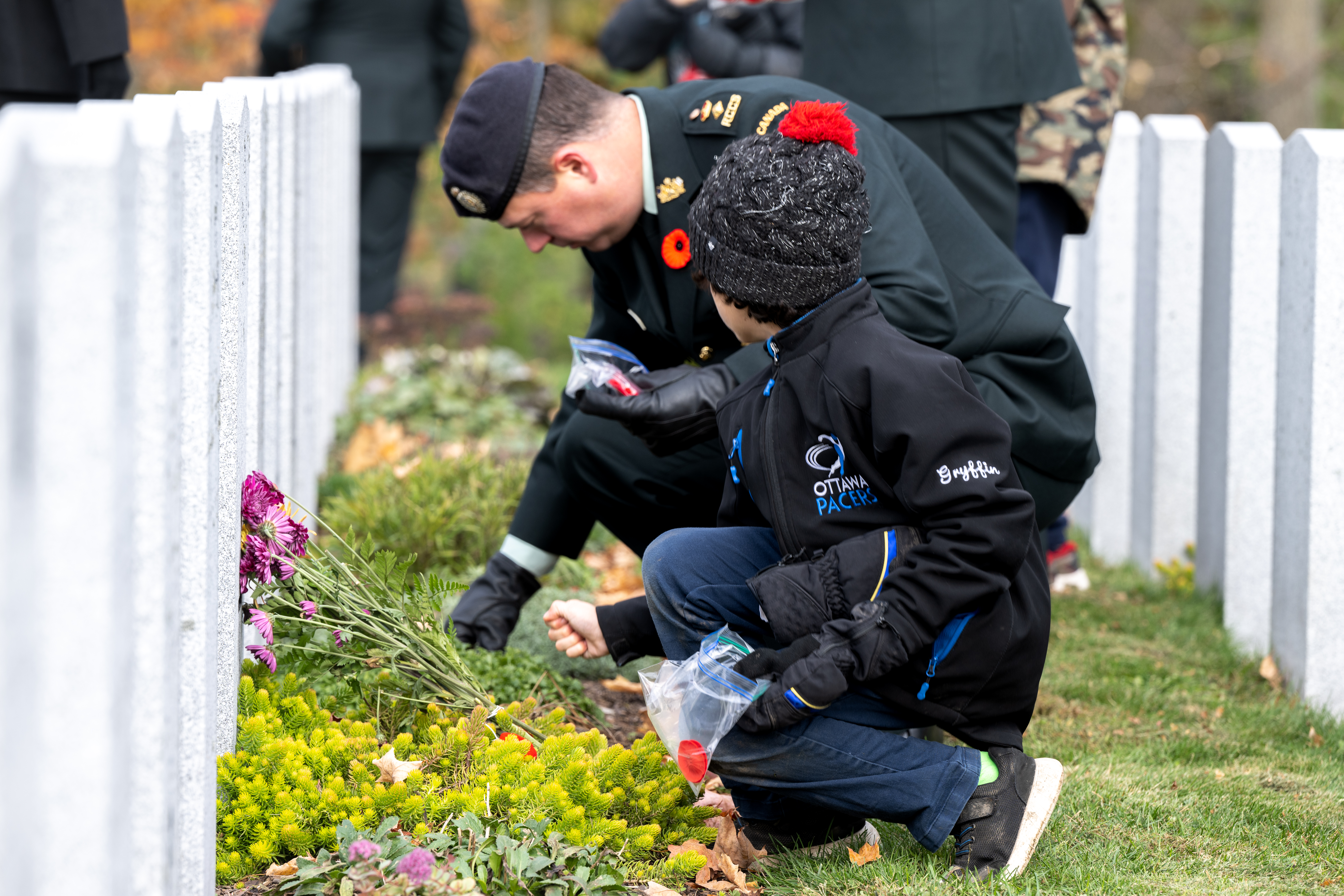 Commander and Child place poppies