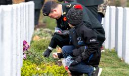 Commander and Child place poppies